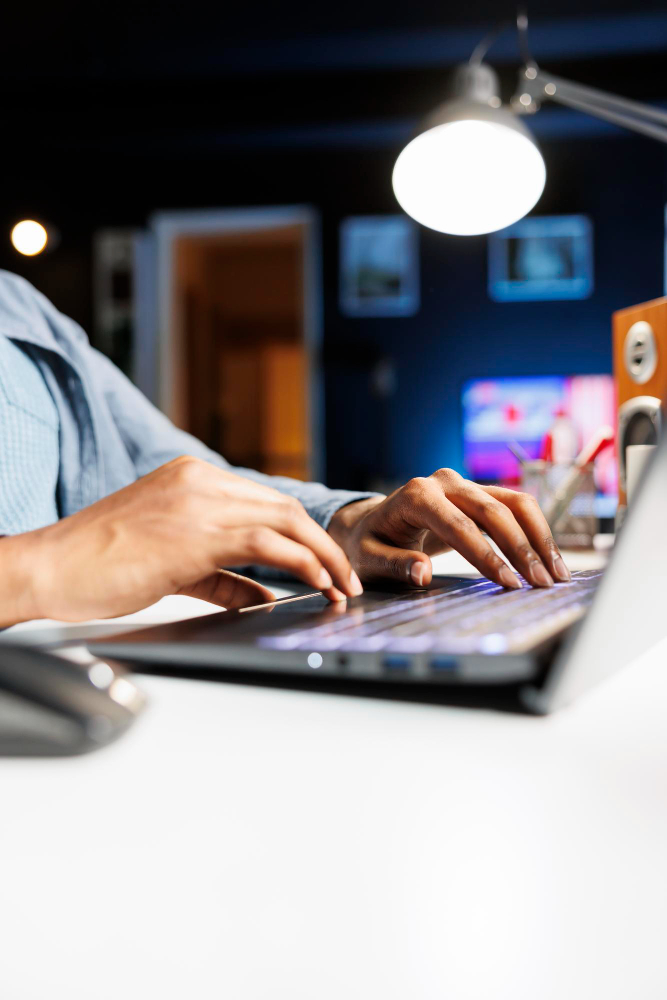 Mãos de um homem branco digittando em um laptop 